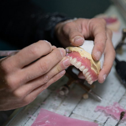 Man carving dentures